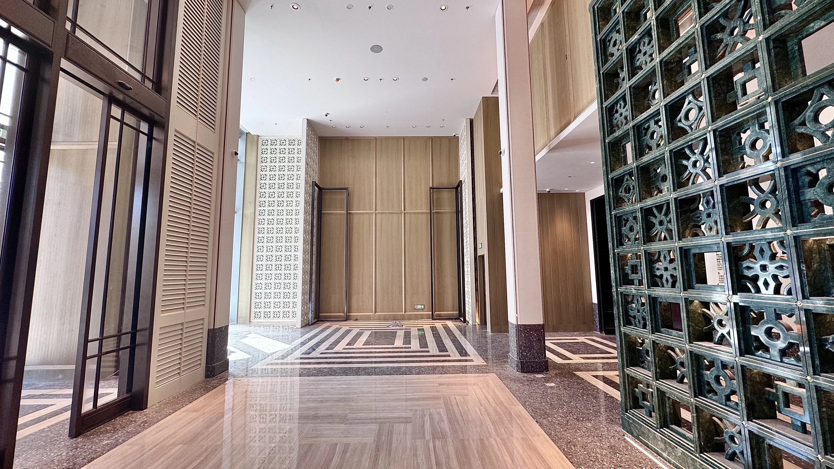 Zhuhai International Tower Hyatt Hotel · Double-height public area · full-height wood panelling